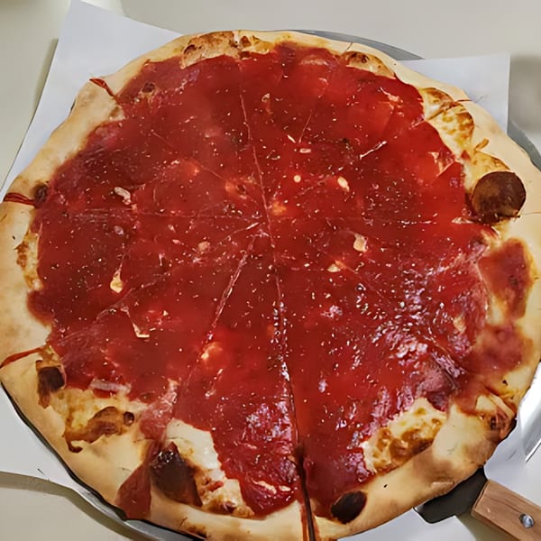 A large, round Franzone's Pizzeria tomato pie, sliced, with a rich red sauce and golden crust.